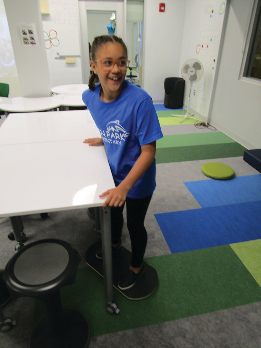 ALL ABOARD: Fifth-grade student Mia McDaniel enjoys one of the balancing boards in the “Mulligan’s Island” room in the Eden Park Learning Community.